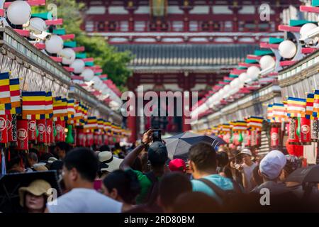 TOKIO, JAPAN - JULI 18 2023: Touristenmassen und Einheimische packen die Nakamise Dori Street in Richtung des Senso-ji Tempels in Asakusa, Tokio Stockfoto