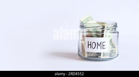 Geld in einem Glasglas. Sparen Sie Geld für Renovierungen oder den Kauf eines Hauses. Dollars in einem Sparschwein Stockfoto