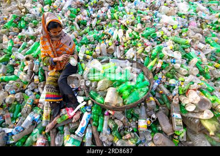 19. Juli 2023, Dhaka, Dhaka, Bangladesch: Arbeiter sortieren gebrauchte Plastikflaschen in einer Recyclingfabrik in Dhaka, Bangladesch. Die Mitarbeiter tragen dazu bei, zu verhindern, dass die Flaschen entsorgt, auf Deponien entsorgt, wo es 1.000 Jahre dauern kann, bis sie biologisch abgebaut sind, oder verbrannt werden, wodurch giftige Dämpfe entstehen. Da die Hauptstadt von Bangladesch, Dhaka, eine der am dichtesten besiedelten Regionen der Welt ist und fast 19 Millionen Menschen beheimatet, ist der jährliche Plastikverbrauch von Dhaka pro Kopf mehr als dreimal so hoch wie der nationale Durchschnitt für städtische Gebiete und liegt bei 22,25 kg. In Dhaka werden täglich etwa 646 Tonnen Kunststoffabfälle gesammelt Stockfoto