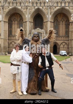 Peterborough, Großbritannien. 18. Juli 2023. Luke Skywalker, Prinzessin Leia, Chewbacca und Han Solo posieren vor der Peterborough Cathedral, bevor eine der größten Star Wars privaten Fansammlungen der Welt in der herrlichen Peterborough Cathedral ab dem 19. Juli zu sehen ist. Die Ausstellung, inoffizielle Galaxien, in der Peterborough Cathedral, umfasst über 120 Ausstellungen, darunter ein lebensgroßer Land Speeder neben seltenen Star Wars-Spielzeugen und -Gegenständen. Peterborough, Cambridgeshire, Großbritannien. Kredit: Paul Marriott/Alamy Live News Stockfoto