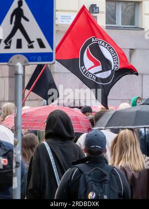 Teilnehmer und eine Antifa-Flagge in der „Nulltoleranz! Rassisten aus der Regierung“, Senaatintori. Stockfoto