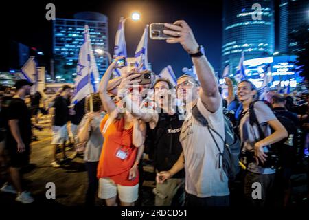 Tel Aviv, Israel. 18. Juli 2023. Demonstranten machen ein Selfie während einer Demonstration in Tel Aviv. Zehntausende Demonstranten blockierten am Dienstag Autobahnen und Bahnhöfe und marschierten im Zentrum von Tel Aviv während eines Tages landesweiter Demonstrationen gegen Premierminister Benjamin Netanjahus umstrittenen Plan zur Justizreform. Kredit: SOPA Images Limited/Alamy Live News Stockfoto