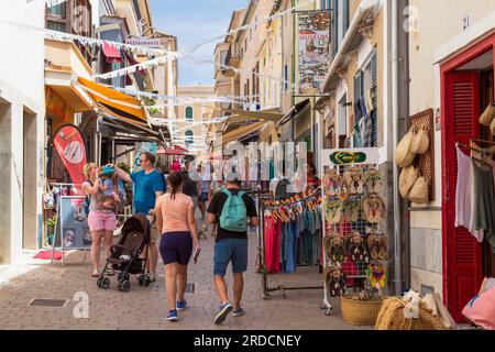 Die Leute gehen durch die gemütliche, enge Straße im historischen Zentrum von Arta, Mallorca, Spanien. Stockfoto