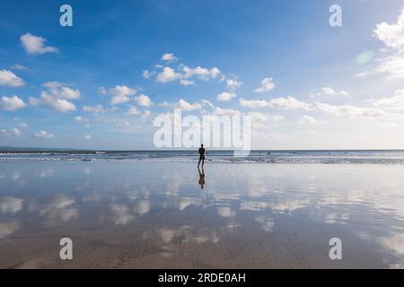 Ein Mann steht am kuta-Strand in Südbali, Indonesien. Stockfoto