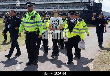 Ein Just Stop Oil Demonstranten wird von der Polizei am zweiten Tag der Open im Royal Liverpool, Wirral, mitgenommen. Bilddatum: Freitag, 21. Juli 2023. Stockfoto