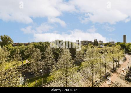 Die Stadt mit Bäumen, Gebäuden und blauem Himmel im Vordergrund – das Bild stammt von einer Luftdrohenkamera Stockfoto