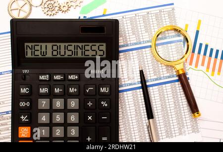 Geschäftskonzept. Auf den Geschäftsdiagrammen befinden sich ein Stift und Aufkleber mit der Aufschrift „New Business“ (Neugeschäft). Stockfoto