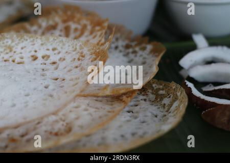 Reiskuchen mit Schnürsenkel serviert mit kerala-Hühnereintopf. Fermentierte Reispfannkuchen aus fermentiertem Reisteig und Kokosmilch. Lieblingsfrühstück Stockfoto