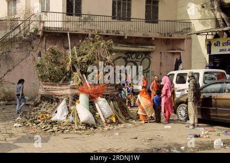 Indien, Neu-Delhi - 1. März 2018: Die indische Familie bereitet sich darauf vor, Holly zu feiern. Ein riesiger Haufen Stöcke und Trümmer mitten auf der Straße in der Nähe Stockfoto