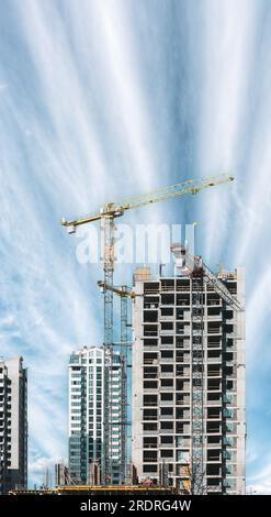 Unglaublich Heller Blauer Himmel Über Dem Baukran. Bau und Entwicklung eines neuen mehrstöckigen Wohngebäudes. Wohnhäuser. Konzeption Von Stockfoto