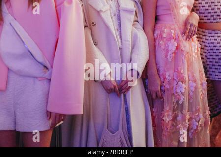 Verkürzte weibliche Figuren in weißer, pinkfarbener, stylischer Kleidung auf der Backstage Fashion Week. Trendiges Outfit, kreatives Bekleidungskonzept. Stockfoto