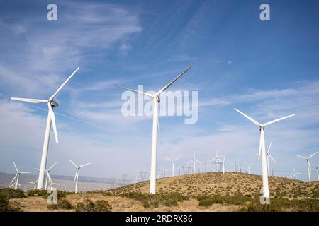 Air mills power station against the blue sky making alternative energy for the future Stock Photo