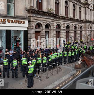 23. Juli 2023 - Polizei kettelt eine Gruppe von Demonstranten in St. Vincent Place im Glasgow City Centre, Schottland, Vereinigtes Königreich Stockfoto