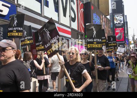 New York City: Der Streik geht weiter unter der Schriftstellergilde von Amerika zusammen mit Mitgliedern der SAG-AFTRA Union mit Streikposten an mehreren Orten in Manhattan. Gewerkschaftsmitglieder demonstrieren durch Paramount Gebäude entlang des Broadway am Times Square, was die Unterhaltungsindustrie lähmt. Stockfoto