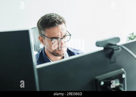 Fernarbeit und Modrn-Verbindung. Virtuelle Online-Besprechung mit vielen Teilnehmern. Webinar. Geschäftsmann, der online mit Mitarbeitern über eine Videoverbindung spricht Stockfoto