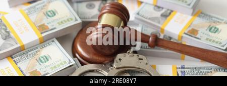 Handschellen und Richter auf Geldpäckchen, Nahaufnahme Stockfoto