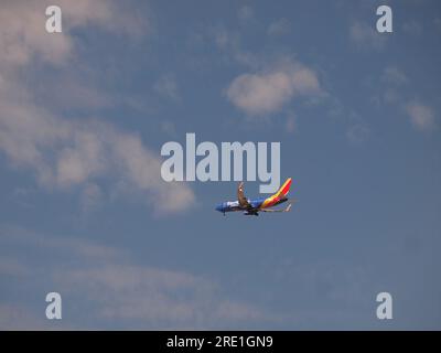 Moderne Düsenflugzeuge nähern sich einem Flughafen. Bei klarem Wetter. Die farbenfrohe Lackierung der Fluglinie macht die gewerblichen Flugzeuge unverwechselbar. Stockfoto