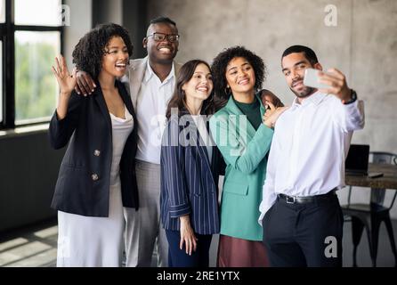 Fröhliches, Vielfältiges Business-Team Macht Selfie Am Telefon Im Büro Stockfoto