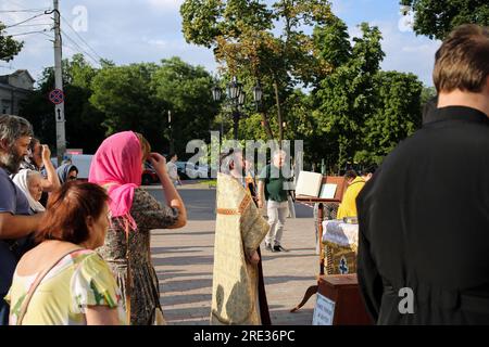 Odessa, Ukraine. 24. Juli 2023. Gemeindemitglieder beten mit Priestern in der Nähe des Eingangs zur beschädigten Kathedrale Spaso-Preobrazhensky (Transfigurationskathedrale) am Kathedralenplatz. Am Tag nach dem Raketenangriff in Odessa. Laut Einsatzkommando "Süd" haben die russischen Truppen in der Nacht des 23. Juli 2023 in Odesa Raketen abgefeuert, mit 5 Arten von Raketen aller Art: Kaliber, Onyx, KH-22, Iskander-M. Die Hafeninfrastruktur, 6 Wohngebäude und die Kathedrale von Spaso-Preobrazhensky (Transfigurationskathedrale) wurden beschädigt. Kredit: SOPA Images Limited/Alamy Live News Stockfoto