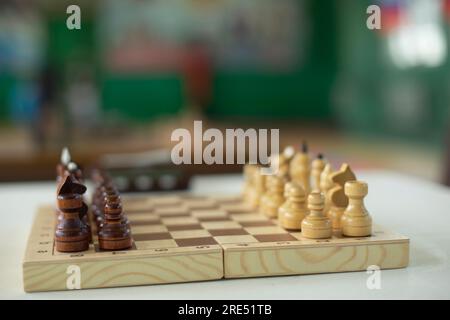 Schachfiguren auf dem Tisch. Schachturnier. Antike Strategie. Spielfiguren aus Holz. Stockfoto