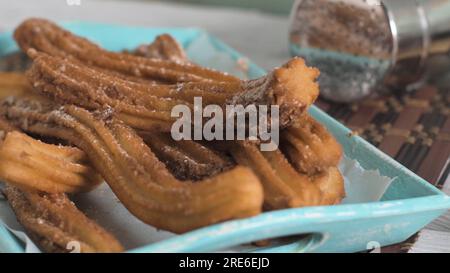 Traditionelle Churros mit heißer Schokolade Soße auf Holz- Zähler nach oben. Stockfoto