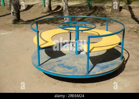 Kinderspielplatz. Karussell auf der Straße. Spielbereich. Ein alter Spielplatz. Stockfoto