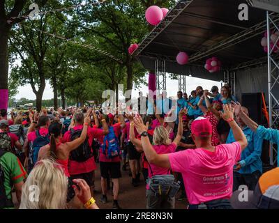 Die Teilnehmer werden beim Tanzen gesehen. Da es sich um das weltweit größte mehrtägige Walking-Event handelt, werden die International Four Days Marches (in niederländischer „De Vierdaagse“) als ein hervorragendes Beispiel für Sportlichkeit und internationale Bindungen zwischen Militärangehörigen, Frauen und Zivilisten aus vielen verschiedenen Ländern angesehen. Dieses Jahr war es die 105. Ausgabe, und die offizielle Anzahl der registrierten Walker betrug 43.363 aus 77 Ländern. Die Teilnehmer können 30km, 40km oder 50km Fuß pro Tag gehen. Am letzten Tag überquerten 39.019 Wanderer die Ziellinie. Nach einem festlichen Eintritt in die Via Gladiola erhielten sie ihre Belohnung Stockfoto