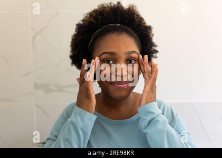 Porträt einer großen afroamerikanischen Frau im Badezimmer Stockfoto