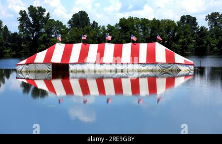 Der Mississippi River überflutet tiefliegendes Land und dieser Feuerwerkstand endet unter Wasser. Reflexion von überfluteten Zelten im Flusswasser bei Memphis, Stockfoto