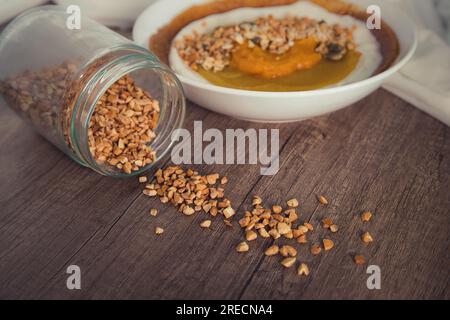 Geröstete Kaschu-Nüsse mit Granulat. Garnieren für Rezepte. Unscharfer Hintergrund. Köstliche und gesunde Smoothie-Schüssel in einer intimen und raffinierten Umgebung. Stockfoto