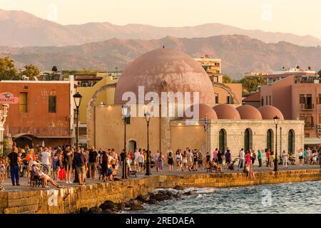 KRETA, GRIECHENLAND - JULI 03 2023: Touristenmassen am Abend in der Nähe der alten Moschee am alten venezianischen Hafen von Chania auf der Insel Kreta Stockfoto