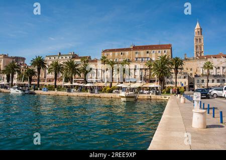 Split, Kroatien - 19 2023. Mai. Riva Ufer in Split. Gesäumt von Bars und Restaurants, ist es bei Touristen und Einheimischen gleichermaßen beliebt. Kathedrale rechts Stockfoto