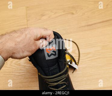 Hamburg, Deutschland - 16. Februar 2022: Männerhand im Blick auf das Logo der Arbeitsschutzschuhe Würth Modyf Stockfoto