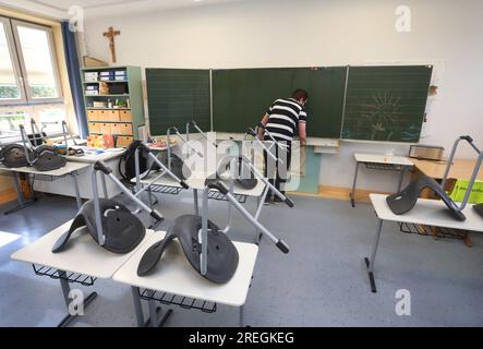 Kaufbeuren, Deutschland. 28. Juli 2023. Ein Klassenlehrer der 4b. Klasse einer Grund- und Mittelschule wischte die Tafel nach der letzten Stunde vor den Sommerferien. Kredit: Karl-Josef Hildenbrand/dpa/Alamy Live News Stockfoto