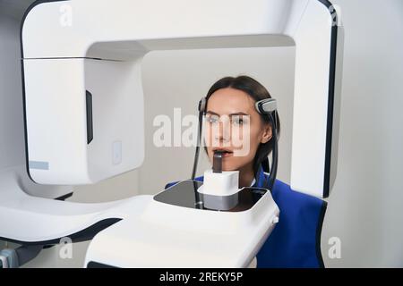 Die schöne Frau wird diagnostischen Verfahren unterzogen 3D-Scans mit modernen Geräten, Stockfoto