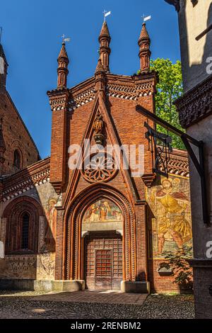 Die Fassade mit ihrer reichen malerischen Dekoration der Kirche im rekonstruierten mittelalterlichen Dorf im Parco del Valentino in Turin. Turin, Piemont Stockfoto