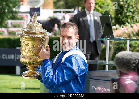 Ascot, Berkshire, Großbritannien. 29. Juli 2023. Jim Crowley hält die Trophäe hoch, nachdem er das King George Rennen gewonnen hat. Prinzessin Anne, die Prinzessin Royal, präsentierte den Besitzer, Trainer und Jockey für die Einsätze King George VI. Und Queen Elizabeth QIPCO. Das Rennen gewann das Pferd Hukum, das von Jockey Jim Crowley geritten wurde. Scheich Hissa und ihr Mann Scheich Maktoum bin Majid Al Maktoum erhielten die Trophäe von der Prinzessin Royal. Eigentümer und Breeder Shadwell Estate Company Ltd Trainer Owen Burrows, Lambourn. Kredit: Maureen McLean/Alamy Live News Stockfoto