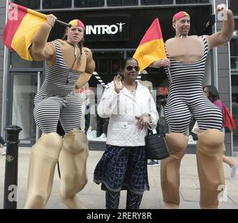 Manchester, Vereinigtes Königreich, 29. Juli 2023. Retro-Rettungsschwimmer mit altmodischen Badeanzügen und Flaggen bieten an, mit Passanten zu posieren, um Fotos und Selfies auf Deansgate neben dem Manchester Airport zu machen. Manchester Day - im Urlaub!, kostenlos, Spaß, familienfreundlich, Veranstaltungen in den Straßen des Stadtzentrums von Manchester, Großbritannien. Unterstützt von Manchester City Council, Manchester Airport Group, Biffa, The Co-op, Manchester Evening News, Wandern Sie auf dem Plank, Kingdom of Sweets, British Firefighter Challenge und Capri Beach Club. Kredit: Terry Waller/Alamy Live News Stockfoto