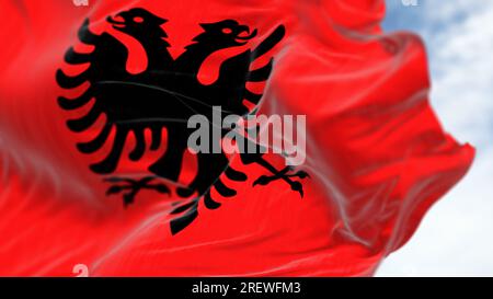 Albanische Nationalflagge, die an klaren Tagen im Wind wehte. Rote Flagge mit schwarzem zweiköpfigen Adler. Rendern der 3D-Darstellung. Flatternder Stoff. Selektiv f Stockfoto