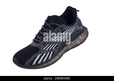 Schwarzer Sneaker mit grauen Streifen auf weißem Hintergrund. Stockfoto