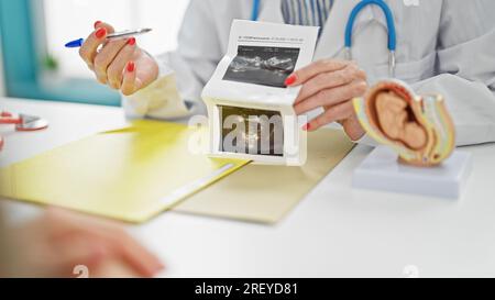 Mittelalterliche Ärztin und Patientin zeigen Ultraschallkind in der Klinik Stockfoto