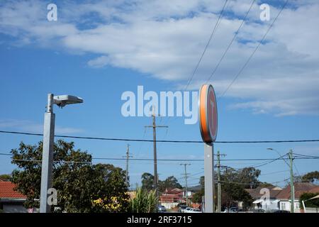 Strommasten und Stromleitungen, Versorgungsleitungen über einer typischen australischen Vorstadtstraße in Canley Vale, West-Sydney Stockfoto