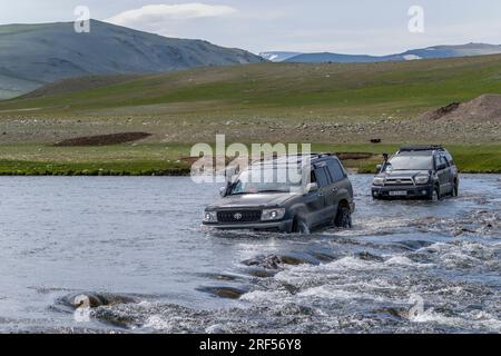 Toyota Land Cruiser, die den Fluss Sagsai in einem abgelegenen Tal im Altai-Gebirge (Altay-Gebirge) in der Nähe von Altai Sum überqueren, ca. 200 km von UL Stockfoto