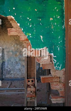 Zerbrochene grüne Mauer in einem verlassenen Gebäude Stockfoto