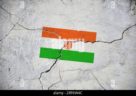 Ein altes Bild der Flagge von Niger an einer Wand mit einem Riss. Stockfoto