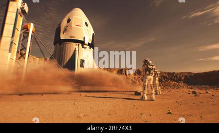 Zwei Astronauten in Raumanzügen, beobachten Raumschiffe, die auf dem Mars landen. Bemannte Raumfahrt auf rotem Planeten. Technologischer Fortschritt der Zukunft. Futuristisches Kolonisierungs- und Explorationskonzept. Stockfoto