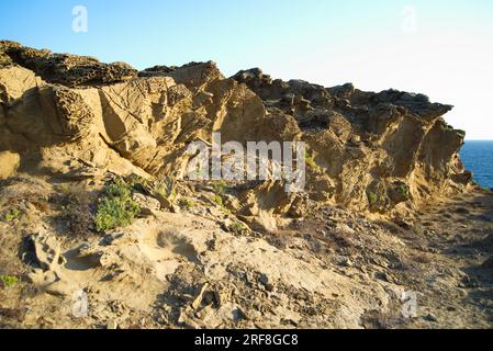 Die Auswirkungen der Winderosion auf die Felsen der menorquinischen Küste werden gezeigt. SE muestra el efecto de la erosión del viento sobre las rocas de la costa Stockfoto