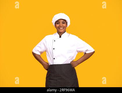 Professioneller Koch. Porträt Einer Lächelnden Schwarzen Köchin In Uniform Stockfoto