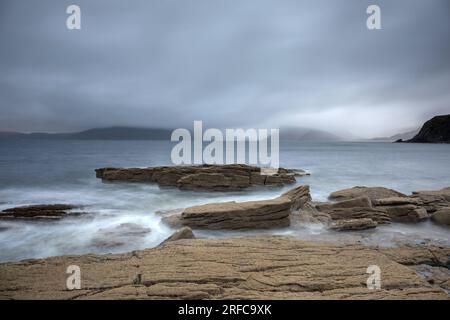 Felsenküste von Elgol mit Blick über Loch Scavaig bis zum Black Cuillin, der in Nebel gehüllt ist Stockfoto