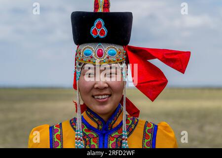 Eine junge mongolische Frau in traditioneller Kleidung in der Gobi Mirage Lodge in der Wüste Gobi, südliche Mongolei. Stockfoto